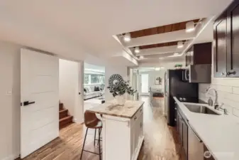 The door off the entry foyer makes the lower level versatile. Close the door to use the space as an ADU for rental income or in-law space. Keep it open for additional living space.