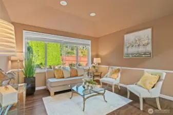 Lovely formal living that could also serve as another family room. Chair molding and vaulted ceilings add to this room.
