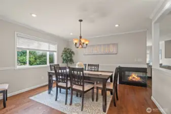 Formal dining that is open to the kitchen. Enhanced by wrap-around gas fireplace, nice for relaxing or entertaining!