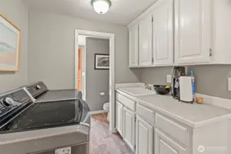 Utility room has 3rd shower, ideal for after-pool use!