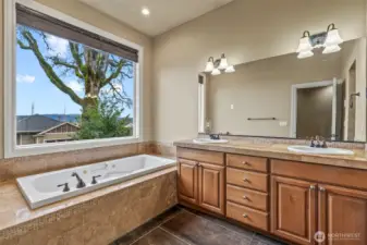 Primary bath with jetted tub, double vanity and heated floors