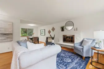 Living room with fireplace and hardwood floors.