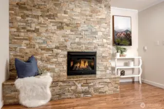 Gather around the stunning stone fireplace in the cozy family room.