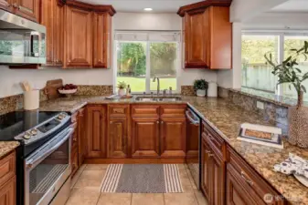 The kitchen is both stylish and functional, featuring granite countertops, stainless steel appliances, and generous cabinetry.