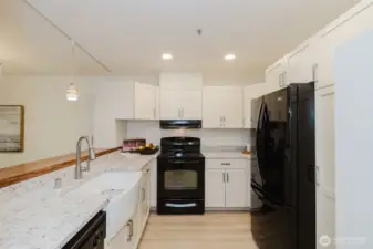 Bright, updated kitchen with quartz counters, farm sink.