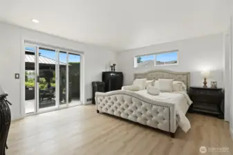 Primary Bedroom with access to the patio and dock just a few steps away.