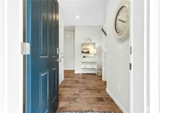 Wide entry with storage under the stairway.