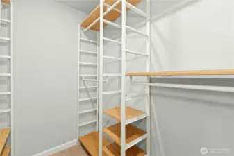 Huge walk-in primary closet with adjustable shelving.