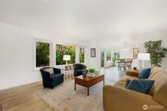 Open-concept layout with abundant natural light and views of lush garden landscaping.