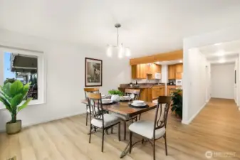 Bright dining area with corner window view and access to the outdoor patio.