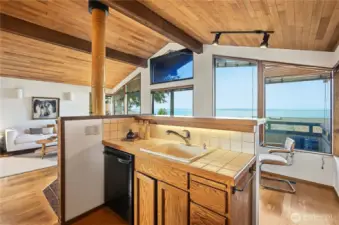Kitchen overlooks family room, deck and westerly views