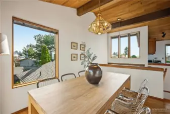 Lovely dining room with big windows and views down the grad 3-story entry stairs