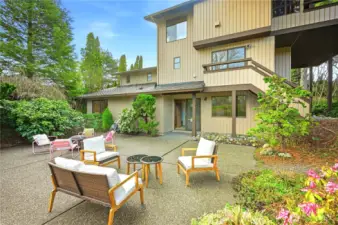 Large entertaining size private patio surrounded by lush garden of mature designed with NW native plants