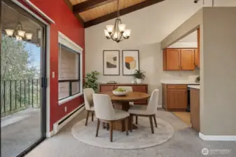 (Virtually Staged) Dining area with vaulted ceilings, large windows, and open flow to the kitchen and living space.
