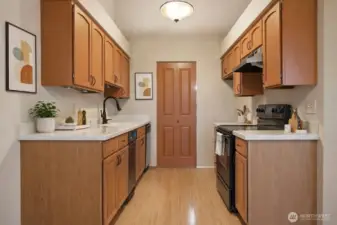 (Virtually Stage) Kitchen with modern appliances, ample cabinetry, adjacent to utility room, with additional shelving space.
