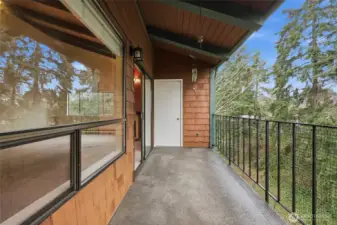 Private balcony with nature views and large storage closet.