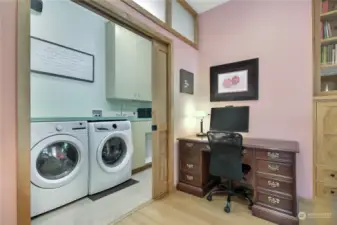 View of utility room off of living room, washer and dryer are included and I love the sink!