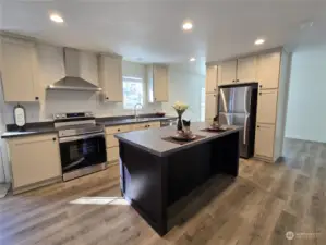 Lots of counter space, stainless steel appliances. and recessed LED lighting to make it light and bright.