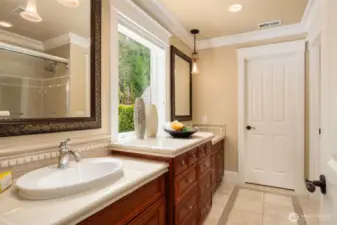 Secondary full bath with dual vanities and designer pendant lighting