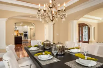 Formal Dining with beaded Italian chandelier and tray ceiling with accent lighting