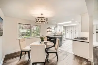 Dining area off kitchen w/ modern light fixtures