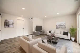 Spacious downstairs living/den w/ access to outside patio & garage **Virtually staged**