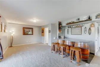 Built in Custom Bar on Lower Level has bar sink, wine fridge and comes with stools