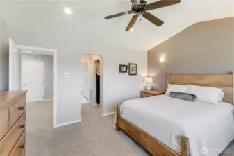 Primary Suite with vaulted ceilings with walk-in closet, closet with shelving & 4 piece bath