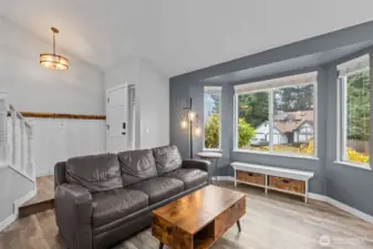 Bright and inviting living area featuring vinyl plank hardwood floors and an open flow.