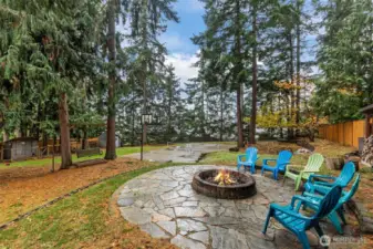 Enjoy cozy evenings by the firepit in your serene backyard setting.