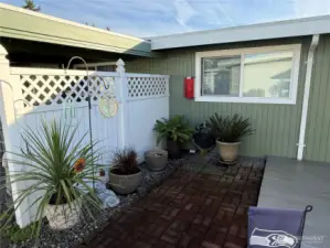 This brick patio is just off the deck and this fence divides the two patio areas from each other.