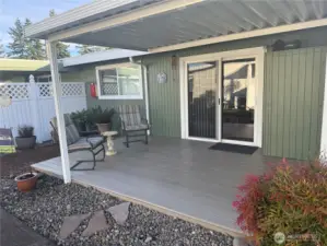 This covered deck is a perfect extension to this home in the summer. Small storage cabinet next to the sliding glass doors.