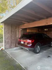 Designated carport with a storage space at the end of the carport spot.