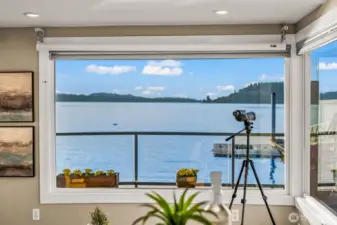Expansive windows frame panoramic water views — the Sound is your everyday backdrop.