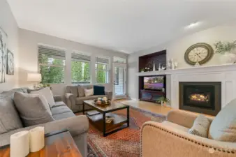 The living room has an extended mantle and the gas fireplace has a beautiful tile and wood surround.