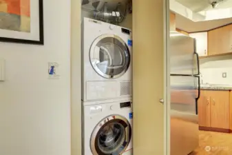 The stacked washer and dryer, conveniently located next to the kitchen, stay with the unit.