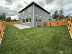 Big backyard with large concrete patio for entertaining