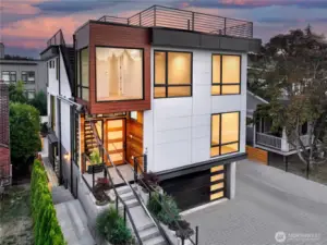 A modern architectural duet at the edge of Ravenna Park. Hawthorne Residences 4015A & 4015B rise with geometric clarity—anchored by steel, warmed by cedar, and crowned with a sky terrace. Framed by native grasses and refined landscaping, the approach sets the tone: clean lines, layered textures, and an intentional rhythm of privacy and light.