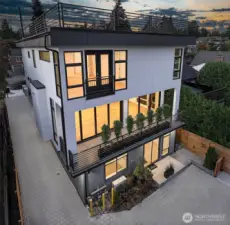 Caption for Image 2 (Rear Elevation - 4015A & B):  From the rear, Hawthorne Residences reveal their full vertical expression—Unit A rises with luminous transparency, while Unit B nestles gracefully below, offering private, full-height living that opens to a secluded courtyard. Thoughtful design maximizes light and livability across both homes, blending architectural clarity with natural connection.