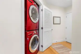 Conveniently located just off the entryway, this dedicated laundry closet features a full-size, front-loading washer and dryer—making everyday chores a breeze without sacrificing space or style.