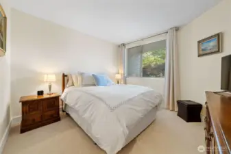 Welcome to the primary suite, a private retreat featuring a spa-like bath and a spacious walk-in closet for effortless organization. A pocket door adds separation from the main living area, enhancing comfort and privacy.