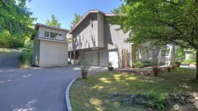 The long, private driveway, redone in 2016, offers ample parking and additional storage options, complete with an added 2 story shed at the front of the property. The area is thoughtfully lined with greenery and decorative rocks, enhancing both function and curb appeal.