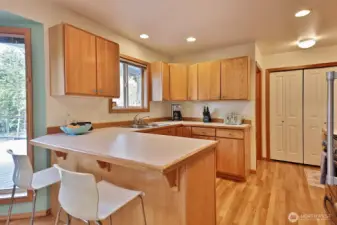 Pantry closet is more spacious and to the right of the pantry is the man door to the garage.