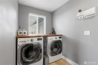 Walnut Shelving can be found throughout the home including in the utility room.
