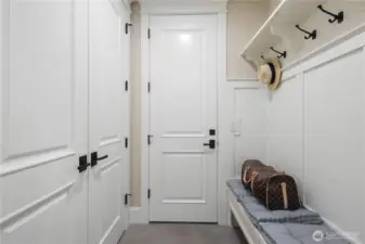 The mudroom, conveniently located off the garage, is the perfect space for organizing and keeping things tidy.
