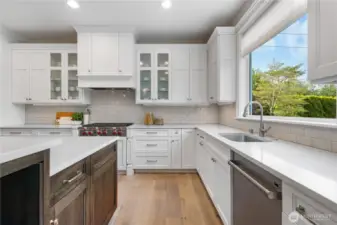 With its timeless finishes, this kitchen is designed to stand the test of time. A large picture window frames stunning views of the downtown skyline and the private backyard.
