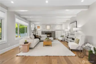 The family room features a cozy gas fireplace, wide-plank oak floors, and a wall of windows that frame sweeping views of the city skyline and its dazzling nighttime lights.