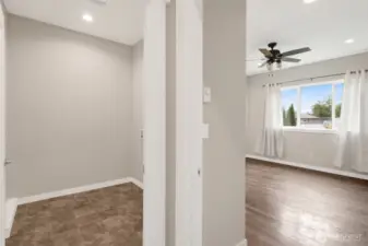 Hallway leads to the laundry room to the left and the primary bedroom to the right. The primary bedroom faces the backyard.