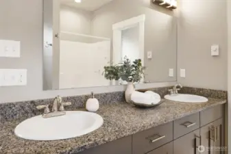 Granite countertops and dual vanity.
