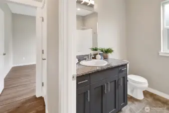 Second full bath in the hallway located between the second and third bedroom. Same cabinetry and granite countertops in the home.